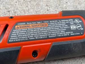 lot 215 image: Black and Decker Wall Mount Rechargeable Saw Model CHS6000