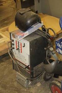 lot 275 image: Montgomery Ward Powr-Kraft 295 Continuous Amperage Control 110-083 Welder, (2) Masks, Extra Welding Rods
