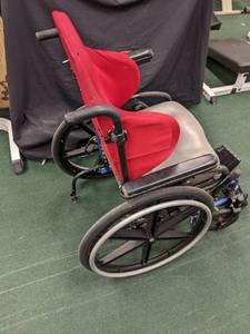 lot 54 image: Wheelchair with red padded seat...