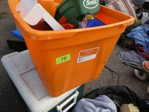 Tote full of seed spreader, charcoal lighter, commercial door opener, caulk etc