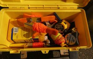 Plastic toolbox with tape measures, survey line and chalk
