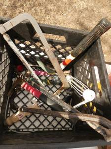 Tote of misc tools including saw, hammers, pry bar, vise, caution tape