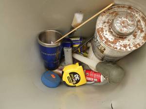 waste basket of wd-40, tape, winch remote, spool of wire, tape, mower blade. Milwaukee sawzall blades