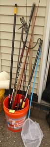 Bucket with fishing rods, shephards hook, and more