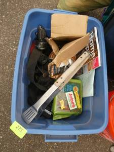 tote with fishing reels, jobes fertilizer, home repair book, nails