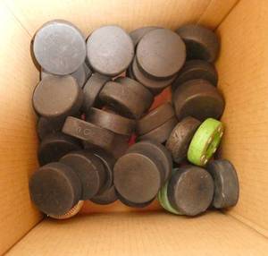Box of about 30 hockey pucks