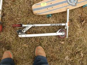 2 razor scooters and a skateboard