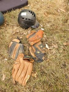 4 baseball gloves and a helmet