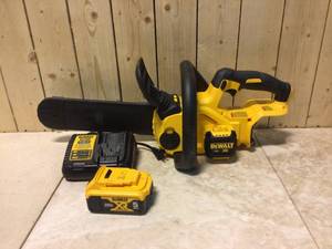 lot 7 image: 12 in. 20V MAX Lithium-Ion Cordless Brushless Chainsaw with (1) 5.0Ah Battery and Charger Included by DEWALT Customer Returns See Pictures