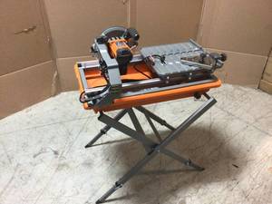 lot 106 image: 9 Amp Corded 7 in. Wet Tile Saw with Stand by RIDGID Customer Returns See Pictures