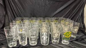 lot 297 image: 35 16 Ounce Glasses- Castle Danger, Guinness, Tilion Brewing, Grain Belt Beer, Indeed Brewing Co., Deschutes Brewery