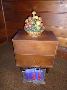 Small wood cabinet with basket on top. As shown.