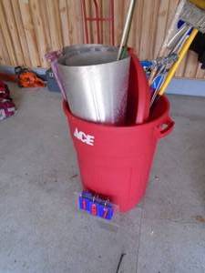 Rubbermaid garbage can with brooms, paint rollers & assorted tools. As shown.