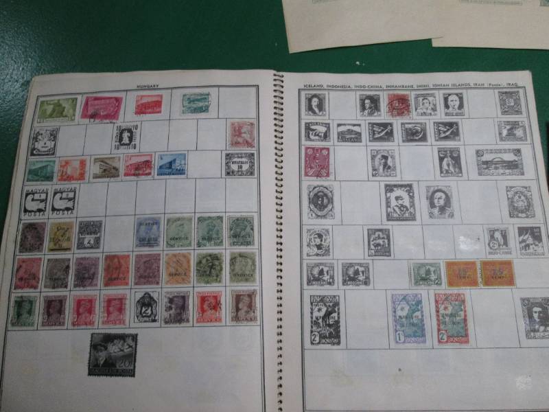 lot 16 image: Stamp album partially filled with stamps, post paid envelopes and postcards, coin holder some pages of the stamp album are stuck together from moisture