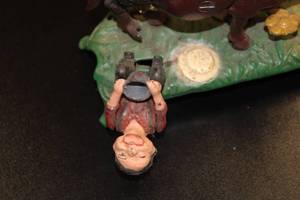 lot 23 image: Vintage Cast Iron Mechanical Bank Milking Cow Repo from The Book of Knowledge