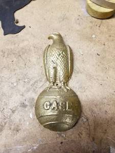 lot 526 image: Case Brass Tractor Emblem