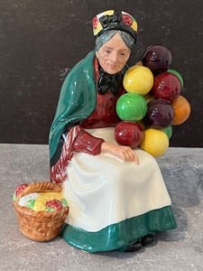lot 13 image: Two Royal Doulton Figurines Royal Doulton The Old Balloon and Balloon Girl Figurines