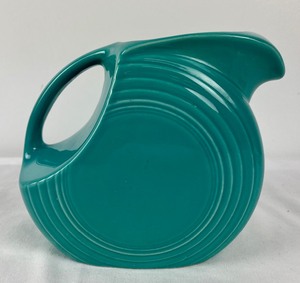 lot 54 image: Large Lot of Teal Fiestaware Plates, Bowls, Mugs, Pitcher, and Teacup