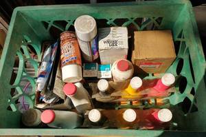 Milk crate full of Fuel Injector cleaner, sealant, 2 cycle oil