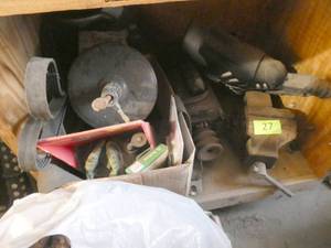 Contents of the bottom cubby of the cabinet - vise, drain snake, motor, roller blades, etc