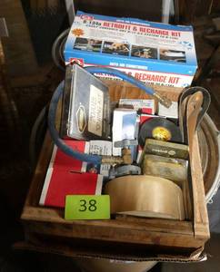 Box with AC recharging kit, orings, and various car parts