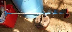 Manual ice auger and gas can