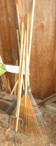 Bamboo leaf rakes and a plastic one, garden rake and a pitch fork