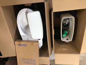 lot 23 image: TOTO Drake 2-piece 1.6 GPF Single Flush Elongated Universal Height Toilet in Cotton White, Seat Included - good condition - review all pictures