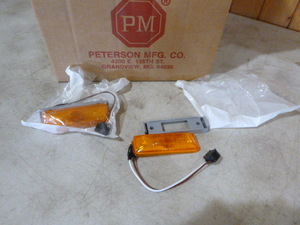 lot 69 image: Case of Peterson Manufacturing Amber Marker Lights