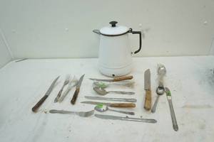 lot 28 image: enamel coffee pot with assorted silverware inside