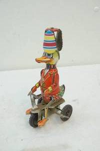 lot 33 image: vintage Schilling wind up carnival duck on bike