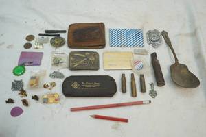 lot 50 image: shell casings and Drott belt buckle