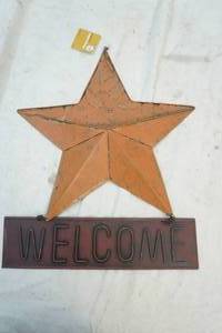 lot 145 image: tin star with welcome sign