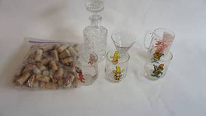 lot 19 image: Vintage Crystal Liquor Decanter w floral etched glass 9 mint -Three assorted Kelloggs glasses -One unique The Band Played On glass mug and bag of corks