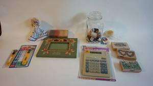 lot 23 image: Assorted crafting lot including apothecary jar with spools of thread, Fabric cutters, Stampin Up Stamps, vintage poker chips, vintage table top calculator new in box etc