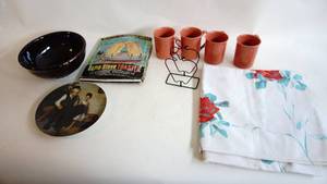 lot 73 image: 10 inch brown pottery USA fruit bowl, Four Corning ware coffee cups, Norman Rockwell plate,  campfire toaster, Apple napkin Holder