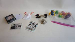 lot 77 image: Vintage Cootie accessories, Silver desk bell, ass kisser cinnamon flavored for the brown Nosers water holder, porcelain cat letter holder Etc.