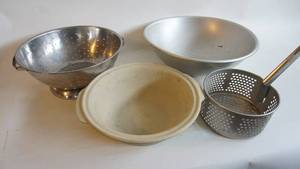 lot 83 image: Pampered Chef 12 inch deep dish baking bowl, Deep fryer  Basket, 13 inch stainless steel colander, 16 inch stainless steel bowl