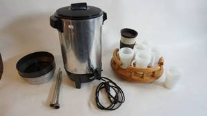 lot 88 image: Six anchor hocking fire king coffee cups, mr. coffee covered mug, 12 inch oak Lazy Susan, Vintage west bend Electric coffee urn with cord