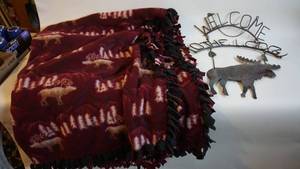 lot 141 image: 54 x 72 hand tied fleece blanket with moosecabin decor and metal welcome sign as is