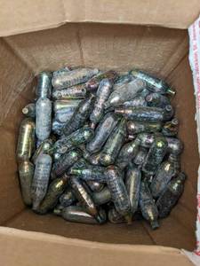 lot 613 image: Box half full of Daisy Co2 cartridg...