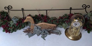 lot 67 image: Home Decor  Anniversary Clock, Scrolled Wrought Iron Wall Hanging with Garland, and Wooden Duck Decor