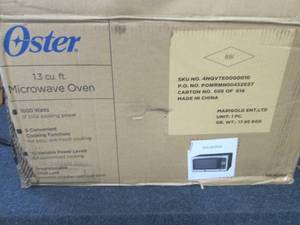 lot 23 image: Oster 1.3 Cu. Ft. 1000-Watt Counter...