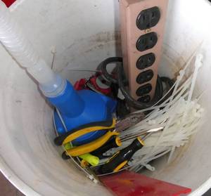 lot 45 image: Bucket of bolts, funnel, outlet strip, zip ties, screwdrivers, plier