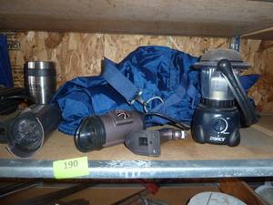lot 190 image: Shelf with camping light, security lights, wind pants, outlet and more