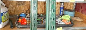 lot 195 image: Shelf with wire, grease, mineral spirits, misc pvc connectors, oil, flags, funnels