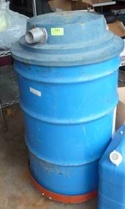 lot 203 image: 55 gallon barrel on wheels, we thought was a vacuum unit but there is not motor inside just hose