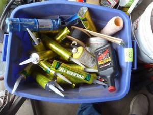 lot 220 image: Tote full of sealant, caulk gun, putty