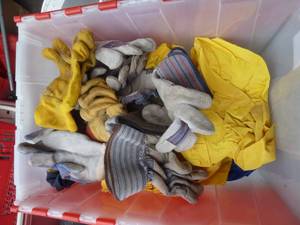 lot 225 image: Tote of work gloves, 2 sets of rain gear, and Sorel boots (missing liner)