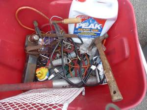 lot 228 image: red tote full of various items including minnow scoops, electrical box, xmas lights, anti-freeze